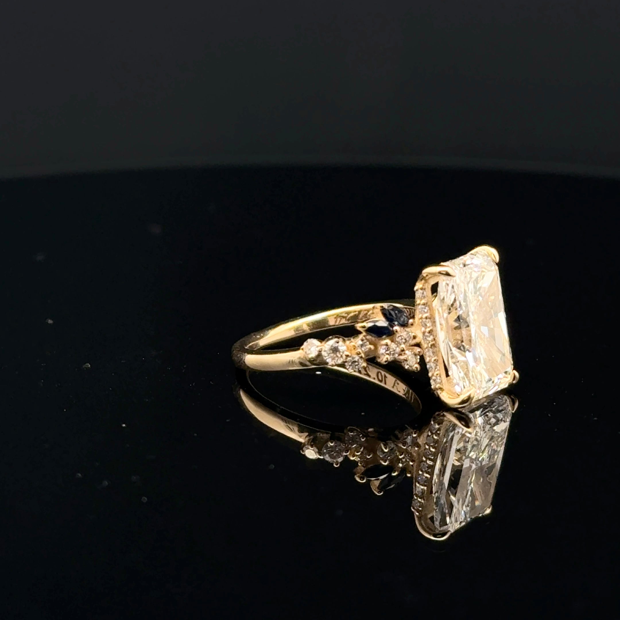 emerald cut diamond multistone custom engagement ring yellow gold side view